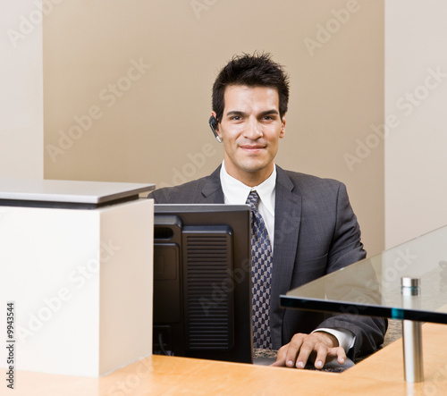 Telephone Earpiece on Photo  Male Receptionist With Telephone Earpiece Working At Front Desk