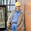 Male construction worker posing in hard-hat and tool belt