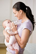 Devoted mother feeding bottle to hungry baby