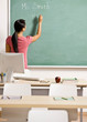 Teacher writing her name on blackboard in school classroom