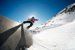 Snowboarder on wall ride with blue sky background