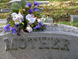 silk flowers on a cemetery grave headstone mother silk flowers on a cemetery grave headstone mother