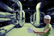 woman engineer, equipment, cables and piping