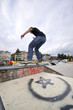 Boy practicing skate in a skate park - isolated