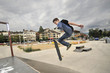 Boy practicing skate in a skate park - isolated