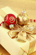 Christmas present with ball in golden and red tone