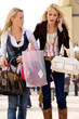 Two young girls shopping in the sunny weather Two young girls shopping in the sunny weather