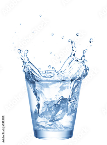 Photo: water splashing from ice cubes being dropped in a glass. water splashing from ice cubes being dropped in a glass.