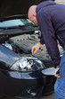 Road breakdown. Man attempts to repair own automobile Road breakdown. Man attempts to repair own automobile