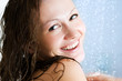 Happy young woman having fresh shower