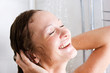 Happy young woman having fresh shower