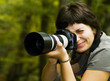 Young female photographer in forest Young female photographer in forest