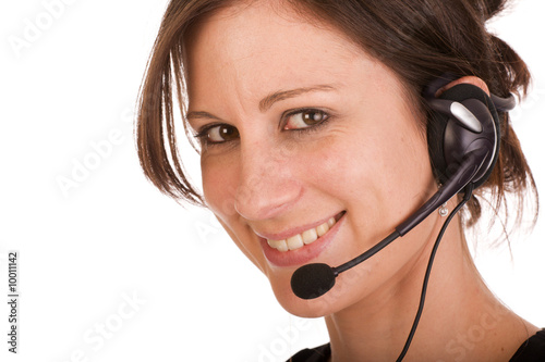 Foto: Young friendly brunette woman with headset Young friendly brunette woman with headset
