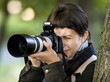 Young female photographer in forest Young female photographer in forest