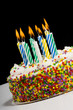 A colorful birthday cake with candles