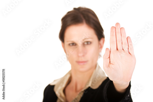 Photo: Brunette business woman holding hand up, looking annoyed Brunette business woman holding hand up, looking annoyed