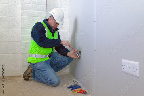 An electrician installing an electrical socket