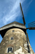 Traditional Old dutch windmill in Latvia against blue sky Traditional Old dutch windmill in Latvia against blue sky