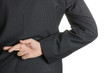 Businessman with fingers crossed behind his back.