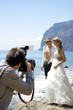 A briding couple photographed by a camera man