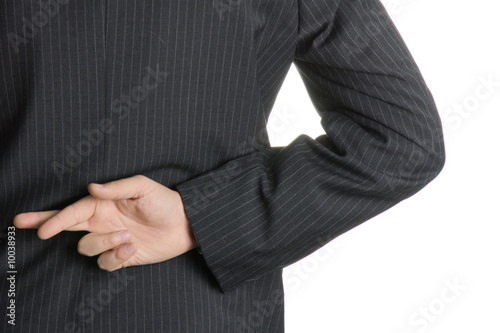 Foto: Businessman with fingers crossed behind his back. Businessman with fingers crossed behind his back.