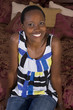 Black woman sitting on bed