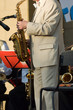 man with saxophone stands on the scene
