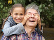 Cheerful daughter surprising her father