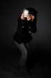 Retro style female photographer with vintage camera and flash