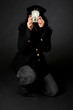 Retro style female photographer with vintage camera and flash
