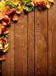 autumn background with colored leaves on wooden board