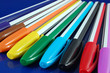colored pens on blue background