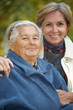 Mother and daughter in the park. Focus on the senior woman.