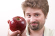 Young man is offering an apple