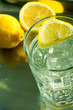 Glass of fresh water with cubes of ice and lemon