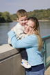 Young mother and little boy playing in local park,