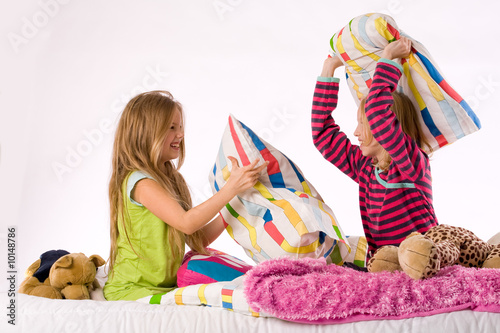 Photo: Two young children enjoying their colorful bed Two young children enjoying their colorful bed