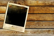 old polaroid frame over wooden wall