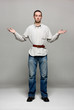 Young man with a belt tightened to the extreme
