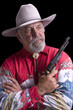 Old Cowboy holding a replica black-powder revolver