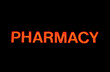 Neon sign with the word "Pharmacy" over black