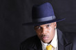 young African American man in a hat and suit