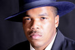young African American man in a hat and suit