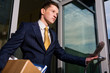 Crisis. Unemployed young manager leaving business center