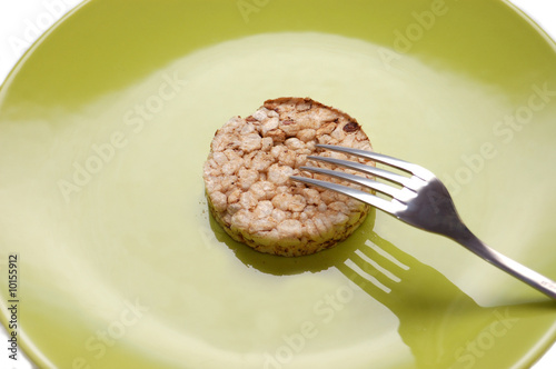 Photo: Strict diet. Green plate with cereal pastry Strict diet. Green plate with cereal pastry