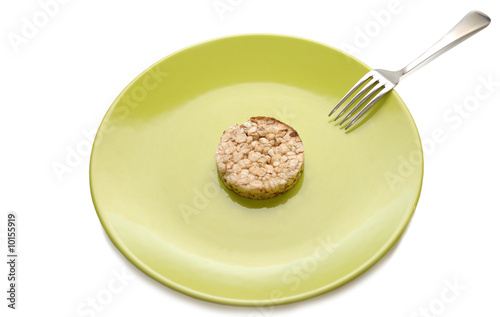 Photo: Green plate with cereal dietary pastry and fork Green plate with cereal dietary pastry and fork