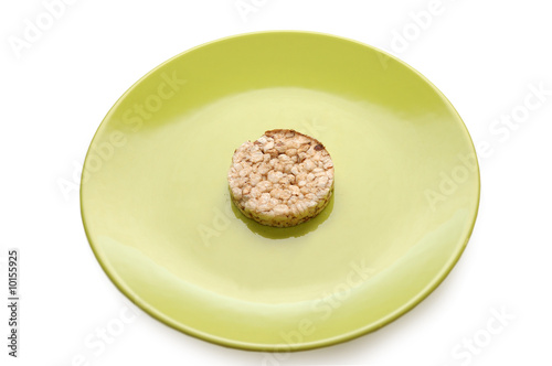 Photo: Strict diet. Green plate with cereal pastry Strict diet. Green plate with cereal pastry