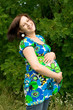 Pregnant woman relaxing on grass