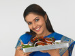 a happy young woman with her roasted chicken