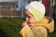 A little girl smells the flower of clover
